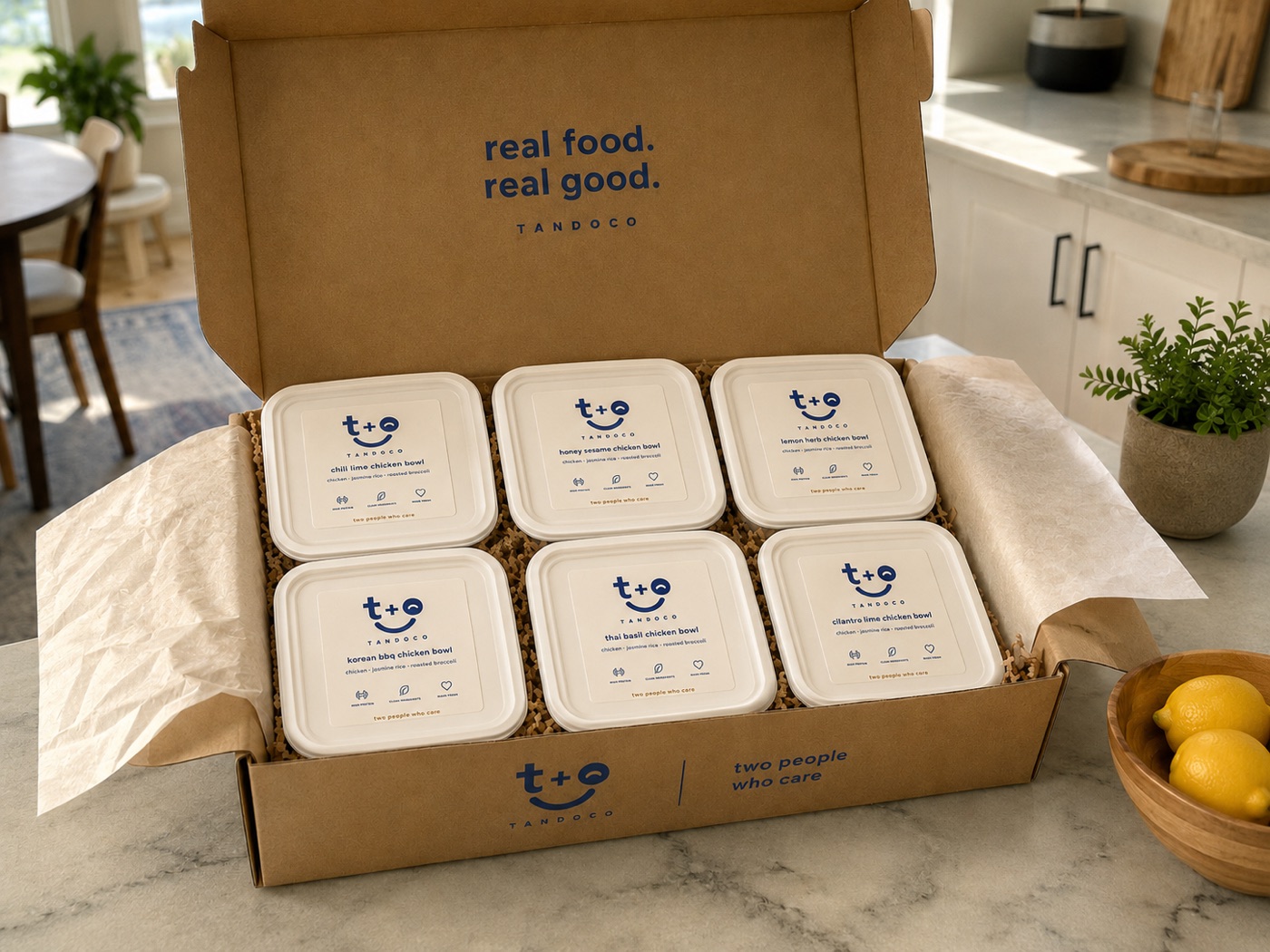 an open tandoco box of six meal-prep trays on a kitchen counter