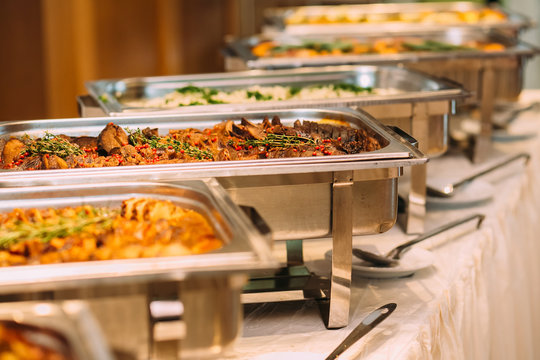 a catering buffet line of scratch-made high-protein dishes in chafing trays for a twin cities event