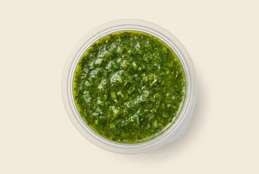 green chimichurri — loose herb sauce, garlic and parsley forward, served by the pint