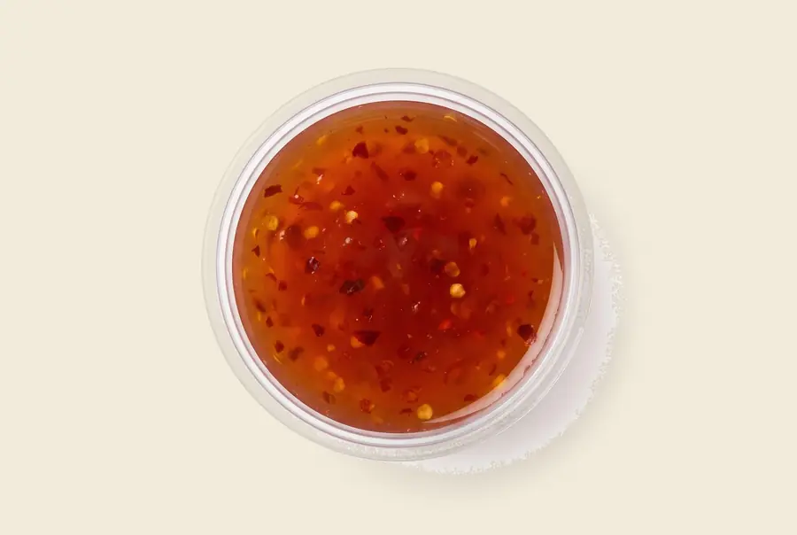 red chili sauce — sweet heat with chili flakes, served by the pint