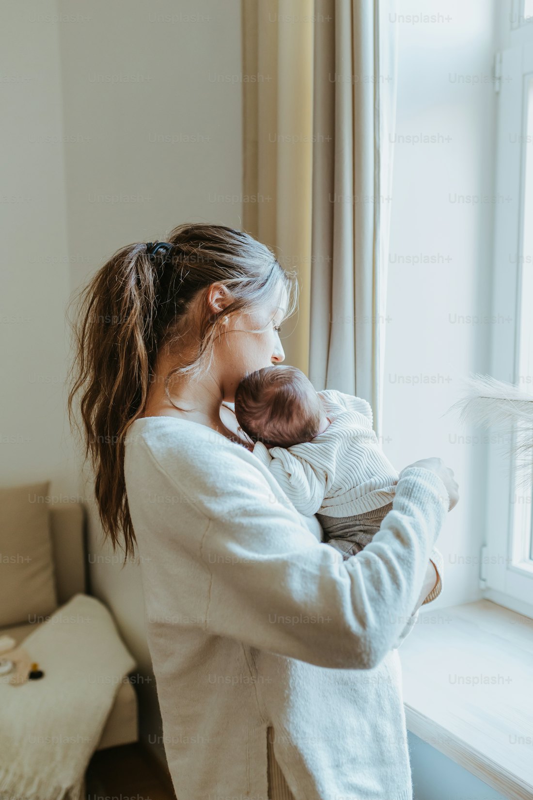 a mom holding her newborn at home