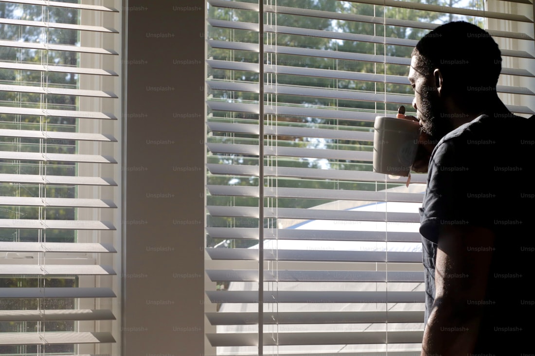 a man with his morning coffee by the window