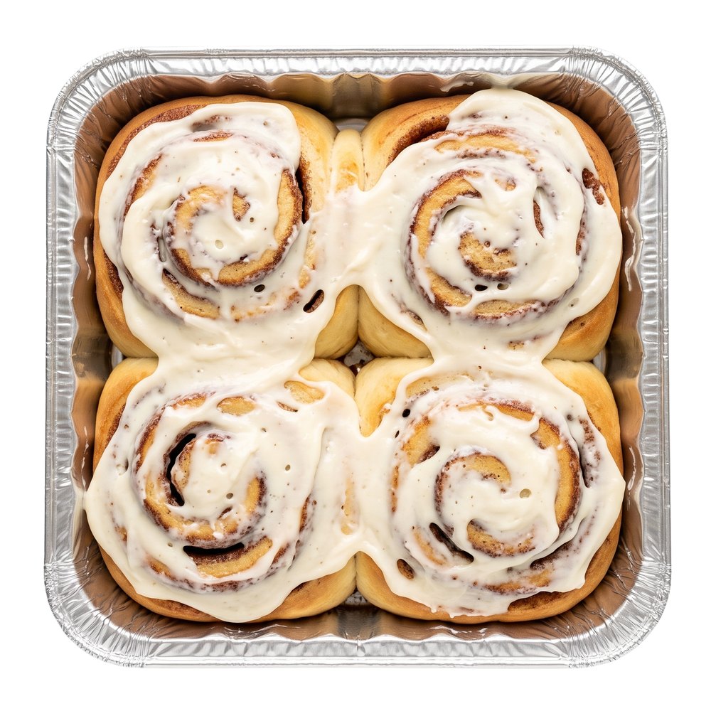 four tandoco swole roll protein cinnamon rolls, iced, in their take-and-bake foil pan